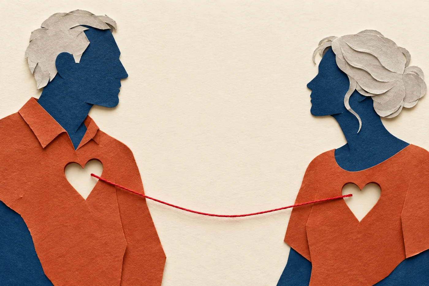 Paper-cut profiles connected by a red thread: an illustration of emotional connection