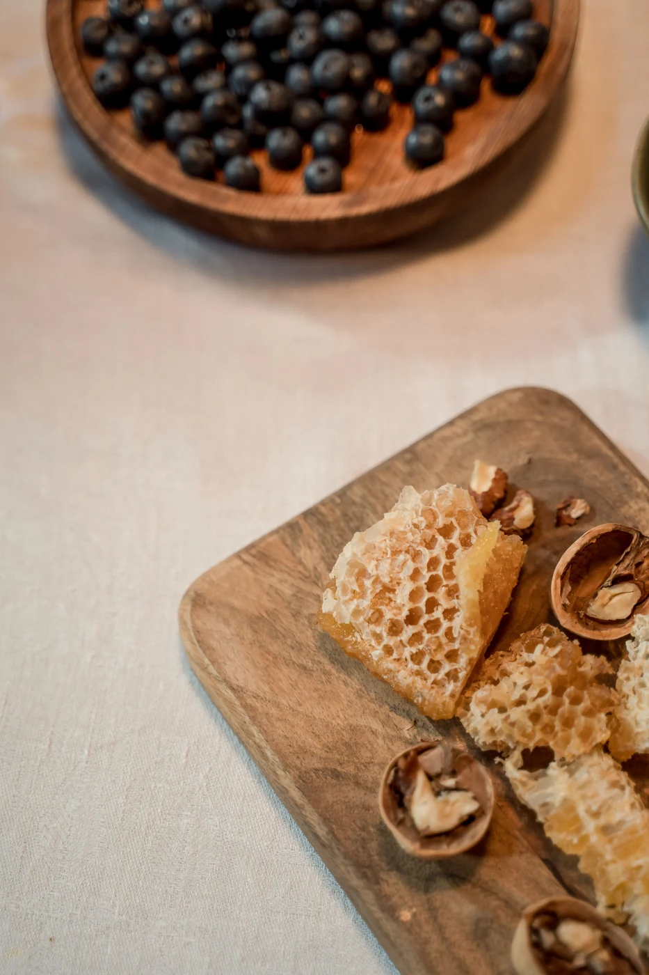 Walnuts and blueberries photographed on a wooden board